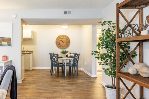 a dining room with a table and a clock on the wall